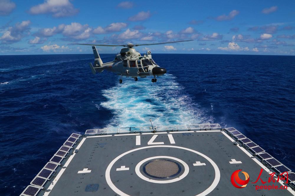 2014年6月13日，海口艦參加多國聯演任務，圖為海口艦直升機升空前出搜索——王棟攝
