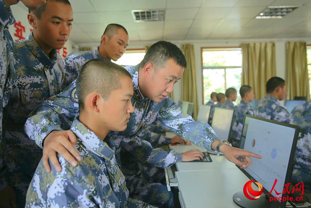 营连干部组织参训战士查阅系统分析结果。