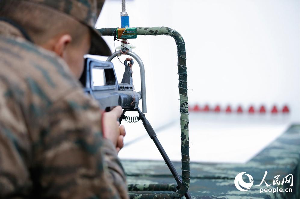 特战队员利用自制训练器材进行机枪射击角度训练。